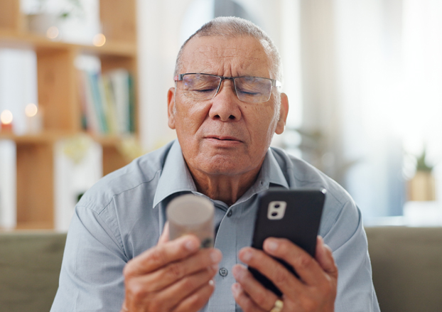 Man looking at prescription bottle